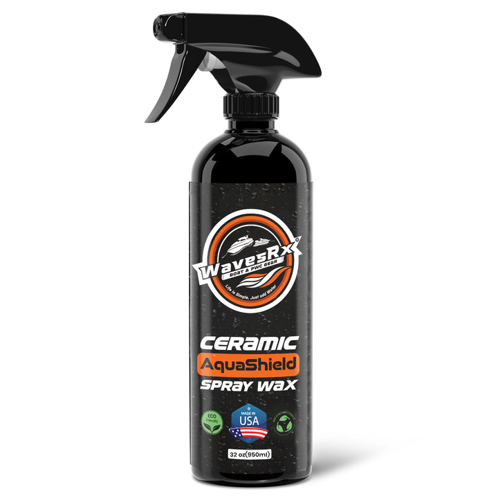 A black spray bottle of WaveRx Ceramic AquaShield Spray Wax on a clean white background. The bottle features a black trigger spray mechanism and a label with orange, white, and black graphics.