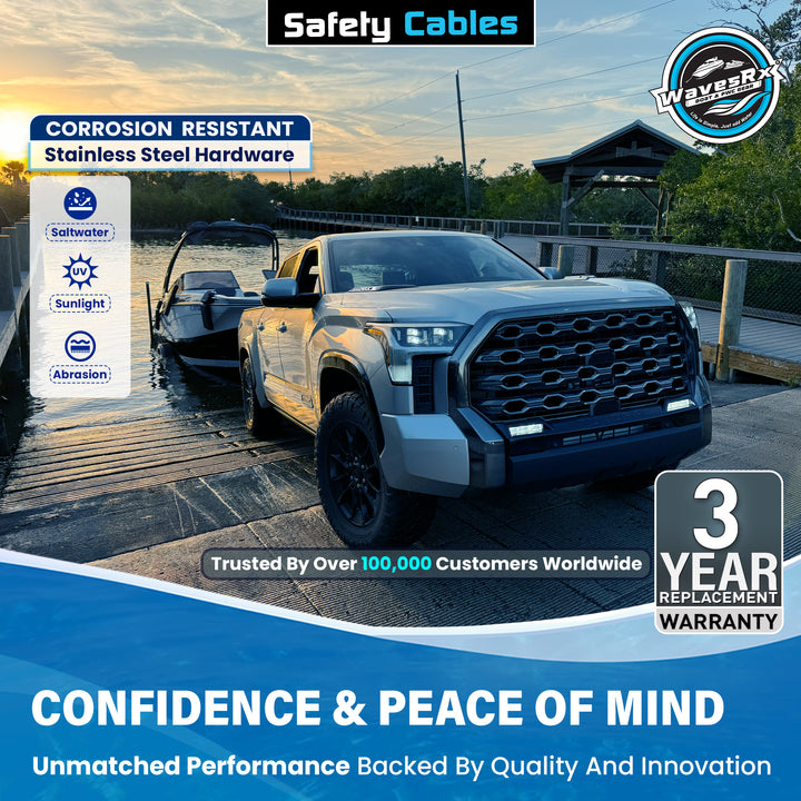 Truck towing a boat with promotional text about safety cables and warranty on a scenic background.